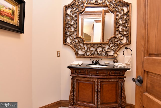 bathroom with vanity and baseboards