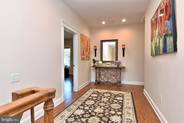 hall featuring recessed lighting, baseboards, and wood finished floors