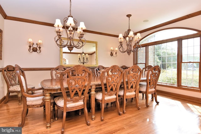 dining space featuring baseboards, light wood-type flooring, a chandelier, and crown molding