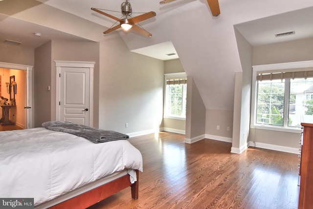 bedroom featuring multiple windows, ceiling fan, and dark hardwood / wood-style flooring