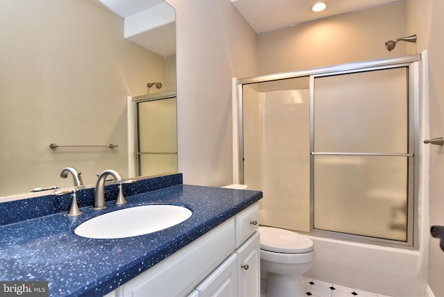 full bathroom featuring enclosed tub / shower combo, toilet, and vanity