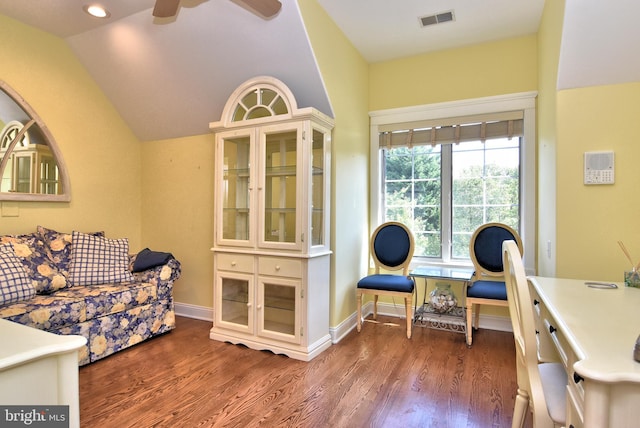 office space featuring lofted ceiling, baseboards, visible vents, a ceiling fan, and wood finished floors