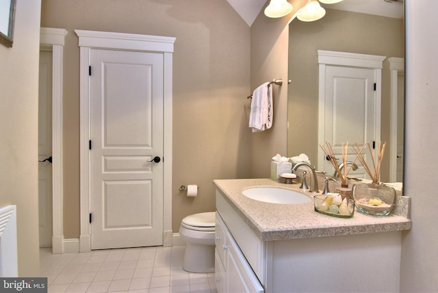 bathroom featuring vaulted ceiling, vanity, ceiling fan, toilet, and tile patterned floors