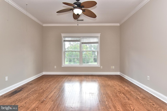 unfurnished room with baseboards, ceiling fan, wood finished floors, and crown molding