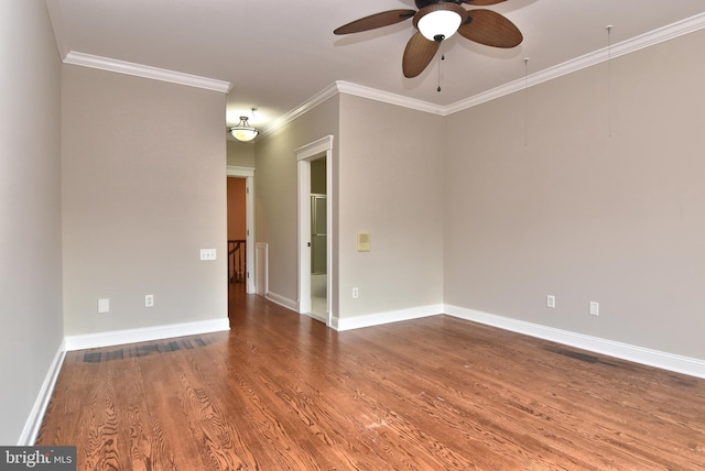 empty room featuring baseboards, crown molding, wood finished floors, and ceiling fan