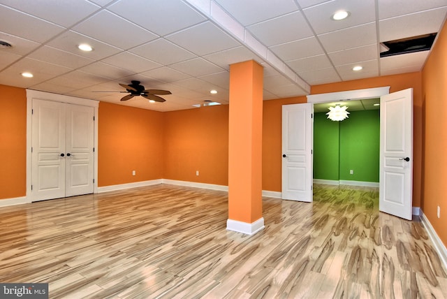 basement featuring ceiling fan, a paneled ceiling, and light hardwood / wood-style floors