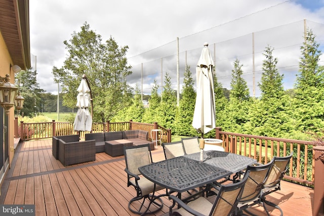 wooden terrace with an outdoor living space