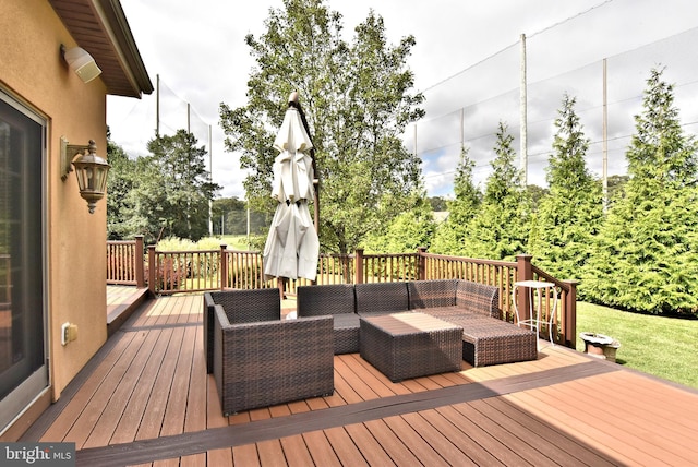 wooden terrace with an outdoor living space