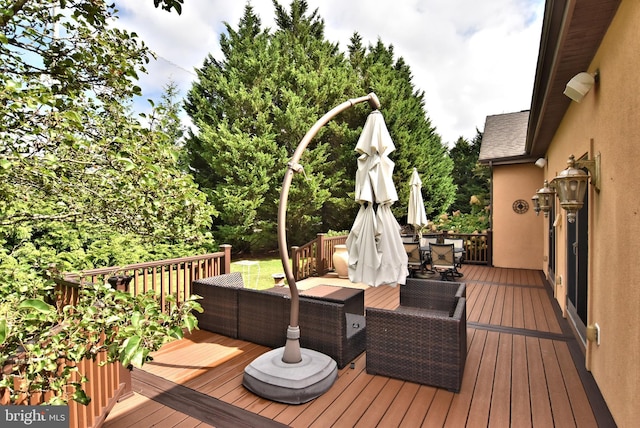 wooden terrace with an outdoor living space