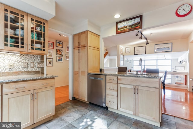 kitchen with hardwood / wood-style flooring, sink, light stone countertops, light brown cabinetry, and stainless steel dishwasher