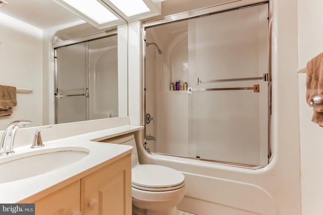 full bathroom featuring bath / shower combo with glass door, vanity, and toilet