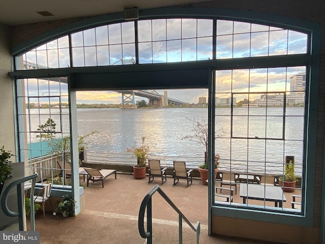 interior space featuring carpet and a water view