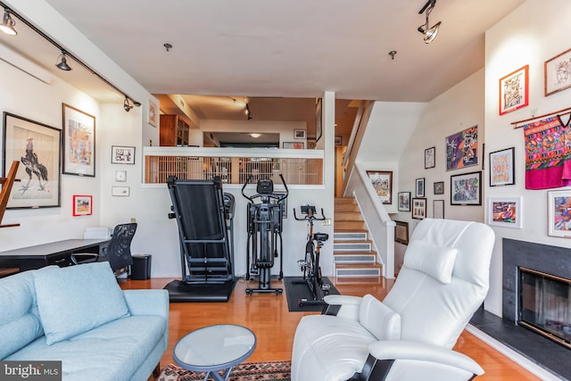 living room with hardwood / wood-style floors and rail lighting