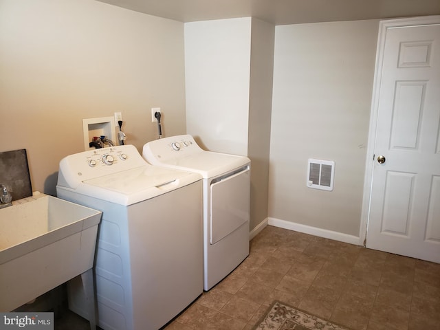 laundry area with sink and washer and dryer