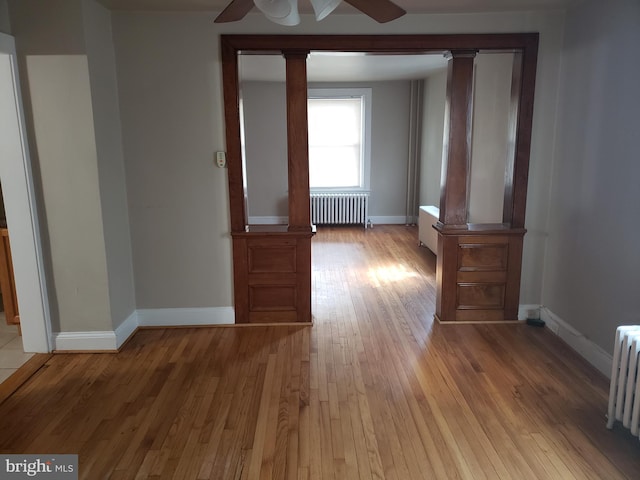 interior space with radiator heating unit and light hardwood / wood-style floors