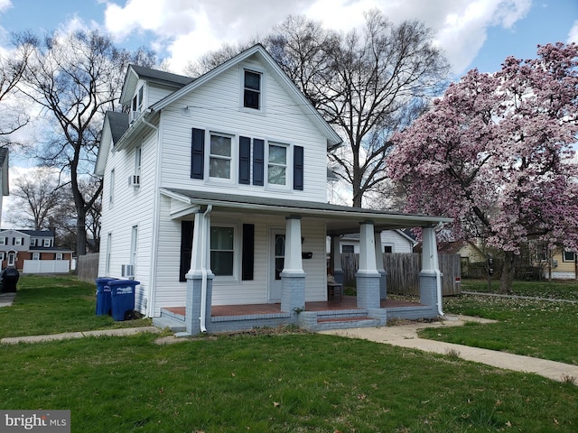 view of property with a front lawn and a porch