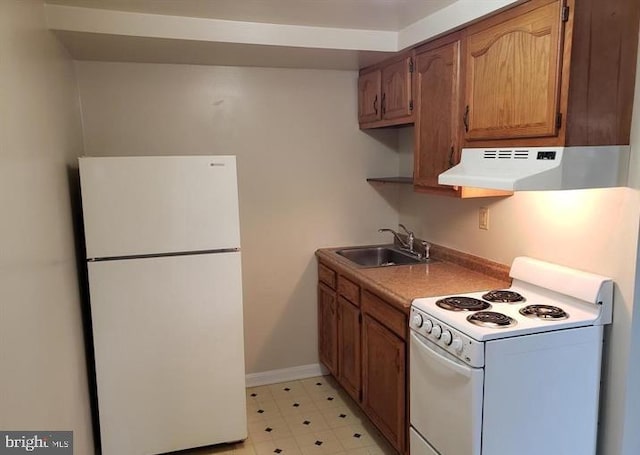 kitchen featuring ventilation hood, white appliances, and sink