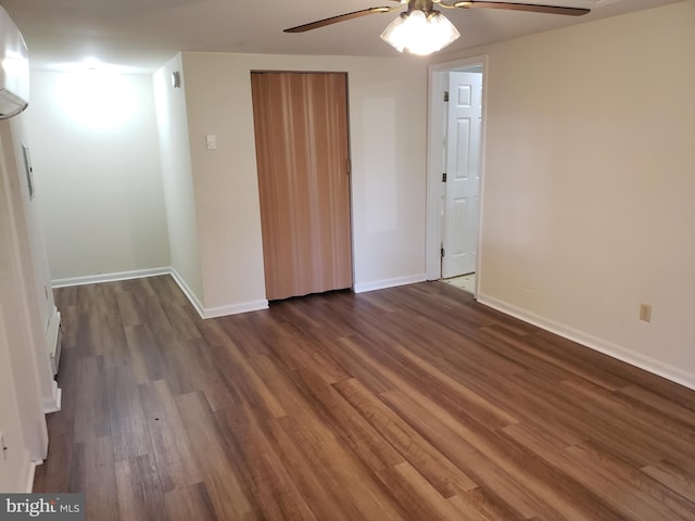 spare room with dark hardwood / wood-style flooring and ceiling fan