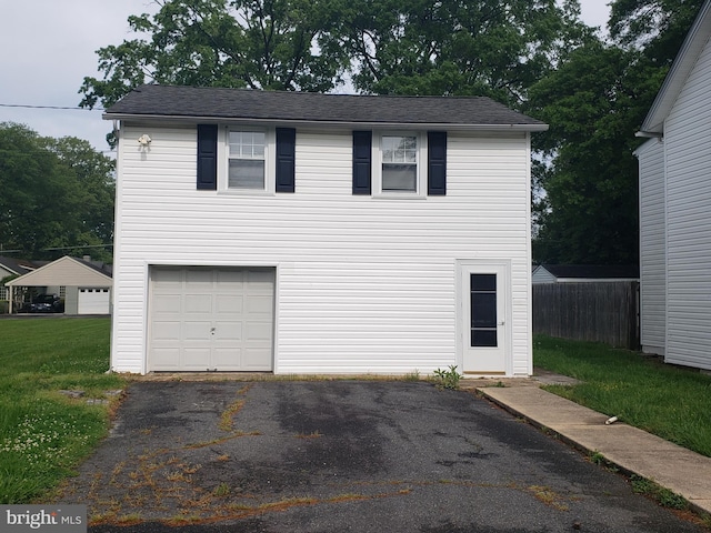 view of front of home with a garage and a front yard