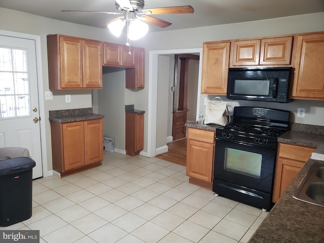 kitchen with ceiling fan, light tile patterned floors, and black appliances