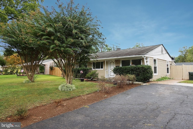 ranch-style home with a front lawn