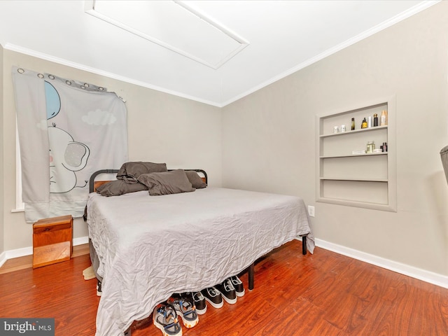 bedroom with wood-type flooring and ornamental molding