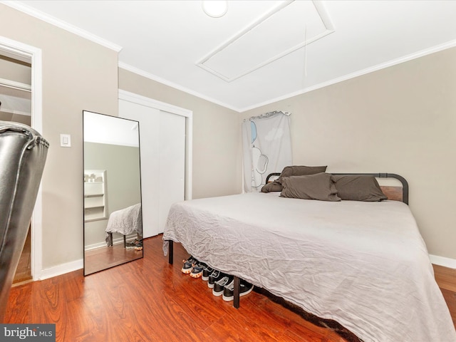 bedroom with wood-type flooring and crown molding