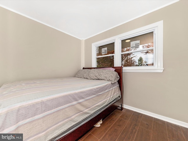 bedroom featuring crown molding and dark hardwood / wood-style flooring