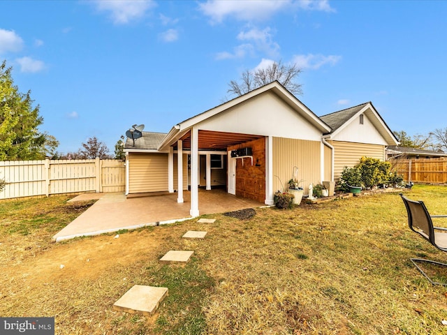 back of property featuring a lawn