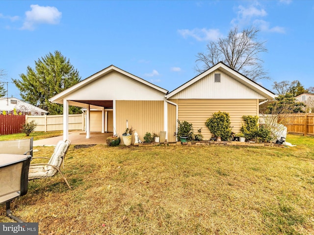 rear view of property with a yard and a carport