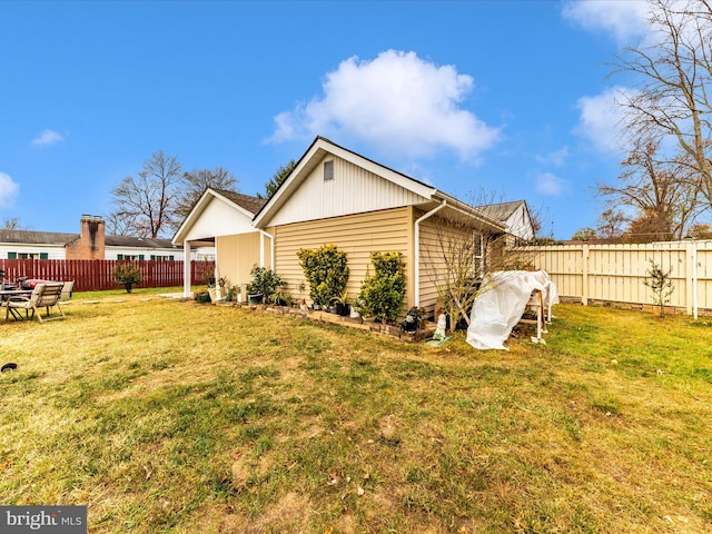 rear view of property featuring a lawn