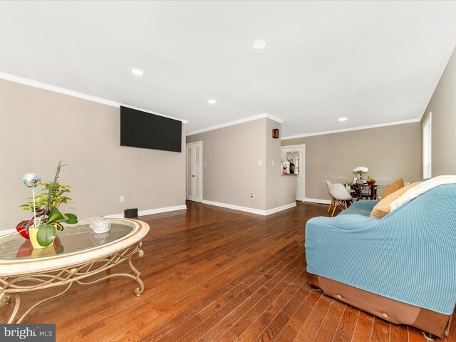 living area featuring dark hardwood / wood-style floors and crown molding