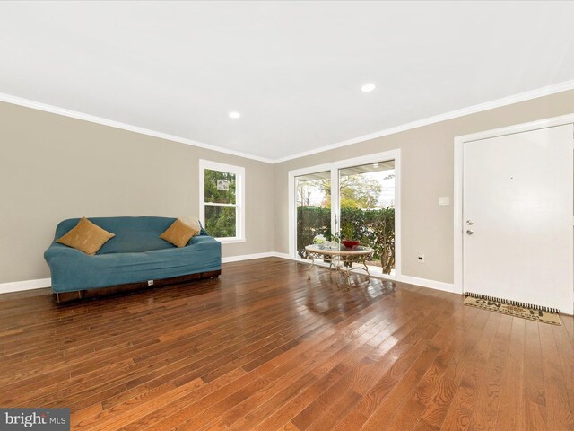 living area with crown molding and dark hardwood / wood-style floors