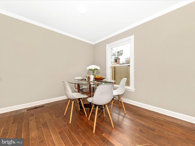 kitchen with sink, wall chimney exhaust hood, ornamental molding, washer / dryer, and stainless steel appliances