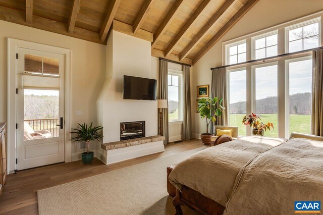 bedroom featuring beamed ceiling, light hardwood / wood-style flooring, high vaulted ceiling, wooden ceiling, and access to exterior