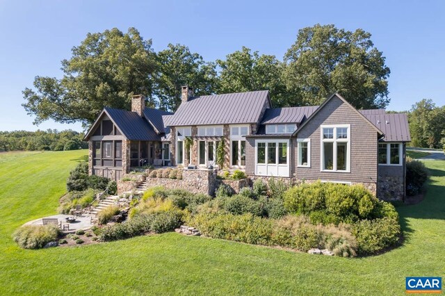 rear view of house featuring a yard