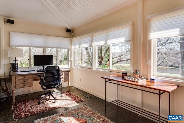 office featuring lofted ceiling, dark hardwood / wood-style flooring, and a wealth of natural light