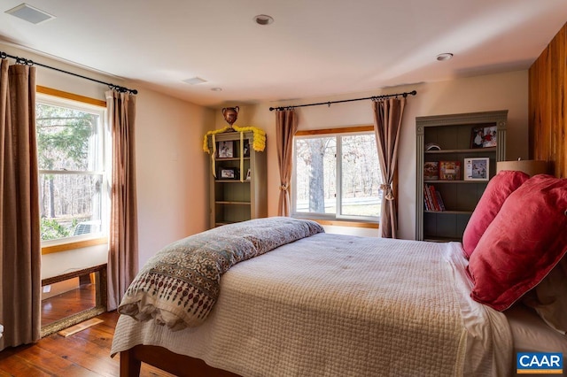 bedroom featuring wood-type flooring and multiple windows