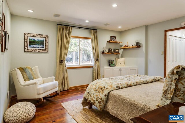 bedroom with a closet and dark hardwood / wood-style flooring