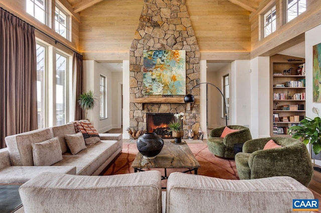 living room with beamed ceiling, a fireplace, and high vaulted ceiling