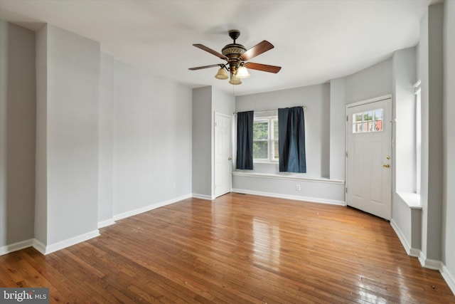 unfurnished room with ceiling fan and hardwood / wood-style flooring