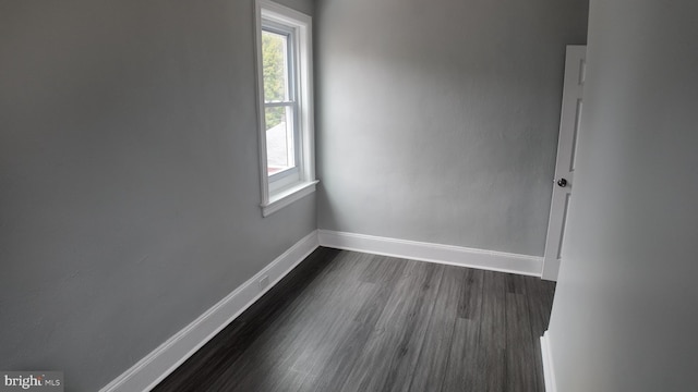 unfurnished room featuring dark hardwood / wood-style flooring