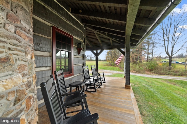 wooden deck featuring a yard