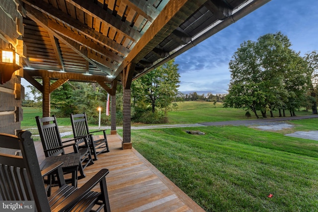 wooden deck with a lawn