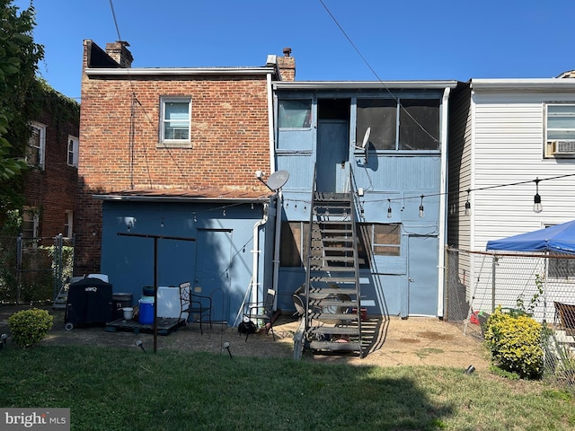 back of property with cooling unit, a yard, and a sunroom