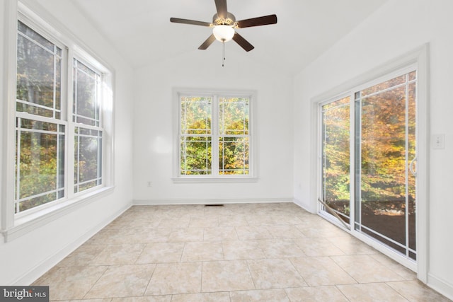 unfurnished sunroom featuring a wealth of natural light, ceiling fan, and vaulted ceiling