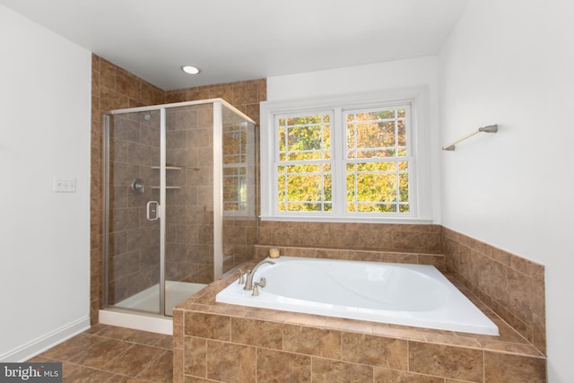 bathroom with tile patterned floors and plus walk in shower