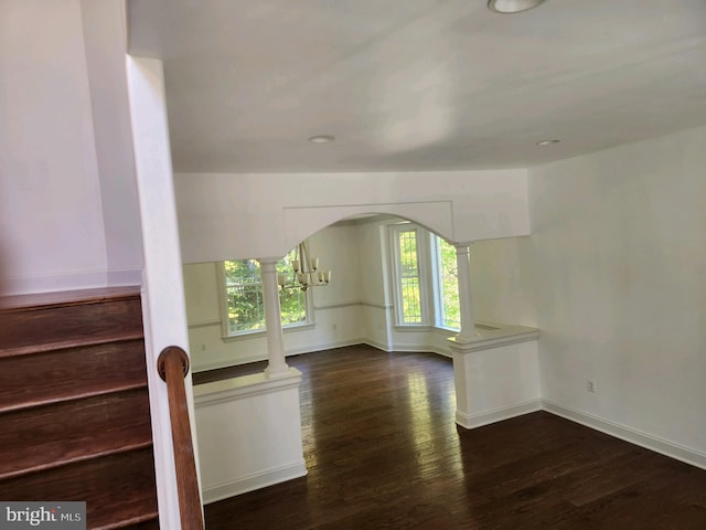 additional living space with a wealth of natural light and dark wood-type flooring