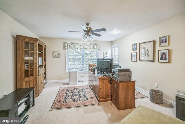 carpeted home office with ceiling fan