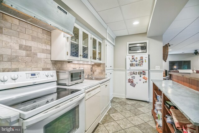 kitchen with ceiling fan, white cabinets, light tile patterned floors, white appliances, and extractor fan